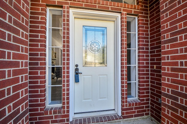 entrance to property with brick siding