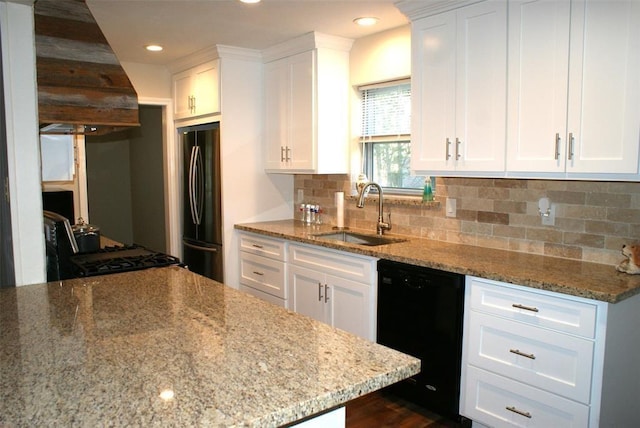 kitchen with black appliances, white cabinetry, and a sink