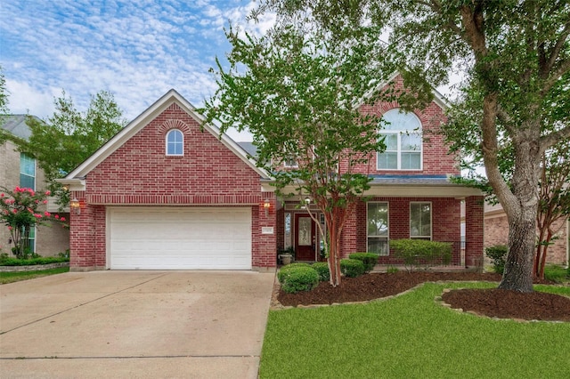 traditional home with concrete driveway, brick siding, an attached garage, and a front yard