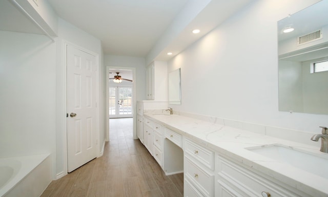 full bath featuring french doors, visible vents, a sink, and double vanity