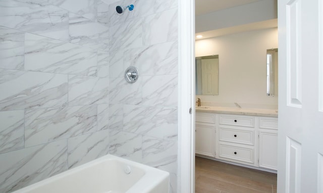 full bathroom with shower / bathing tub combination, vanity, and wood finished floors