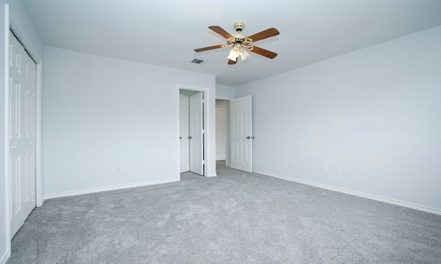 unfurnished bedroom featuring a closet, carpet, visible vents, and baseboards