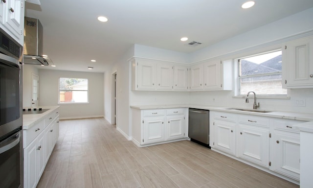 kitchen with light countertops, dishwasher, a sink, and white cabinetry