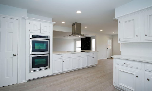 kitchen featuring white cabinets, island exhaust hood, black electric stovetop, stainless steel double oven, and recessed lighting