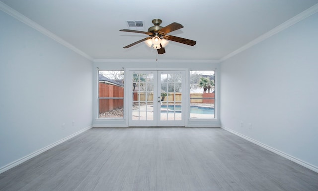 unfurnished room featuring french doors, visible vents, baseboards, and wood finished floors