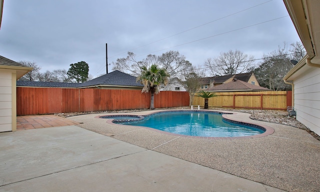 view of pool with a patio area, a fenced backyard, and a pool with connected hot tub