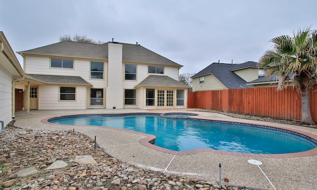 view of pool with a patio area, a hot tub, a fenced in pool, and a fenced backyard