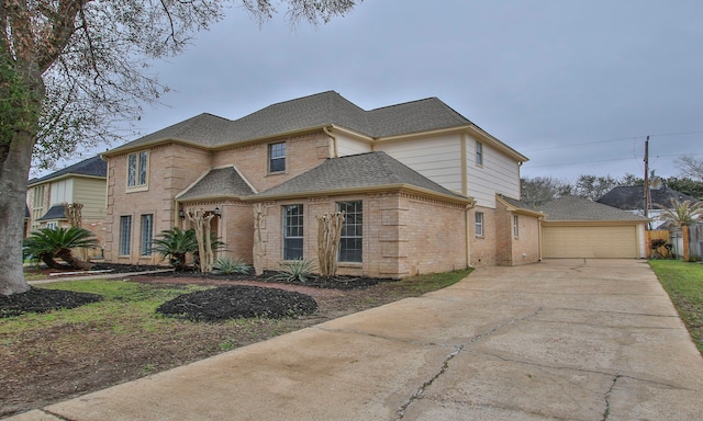 view of front of house with a garage, brick siding, and roof with shingles