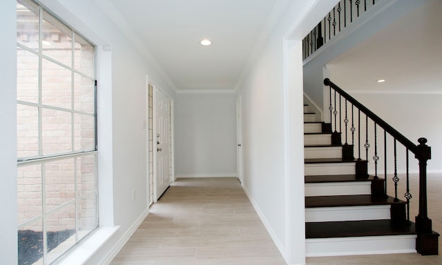 hallway with ornamental molding, recessed lighting, and baseboards