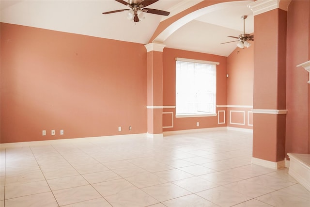 empty room featuring light tile patterned floors, ceiling fan, arched walkways, and vaulted ceiling