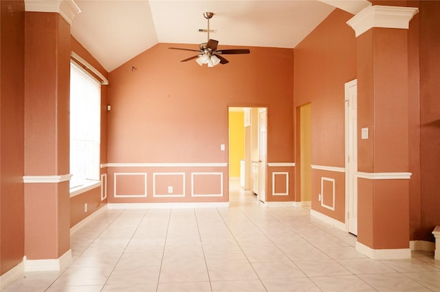 spare room featuring light tile patterned floors, a decorative wall, a ceiling fan, vaulted ceiling, and decorative columns