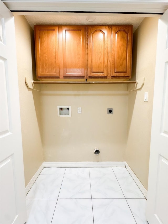 clothes washing area featuring hookup for a washing machine, cabinet space, baseboards, and hookup for an electric dryer