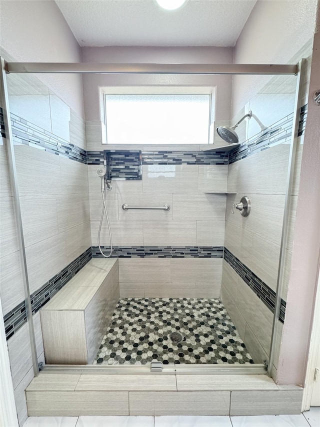 bathroom featuring a stall shower and a wealth of natural light