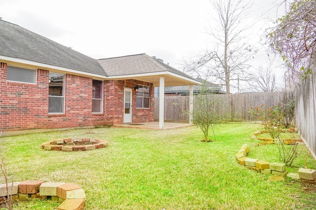 view of yard featuring a fire pit, a patio area, and a fenced backyard