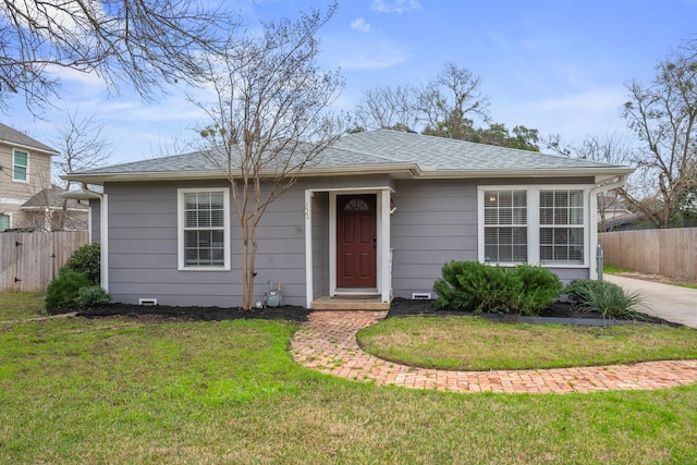 ranch-style house with roof with shingles, crawl space, a front yard, and fence