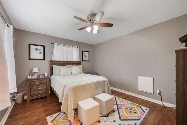 bedroom with ceiling fan, dark wood-type flooring, and baseboards