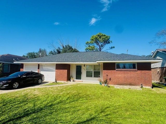 single story home featuring a shingled roof, concrete driveway, an attached garage, a front lawn, and brick siding