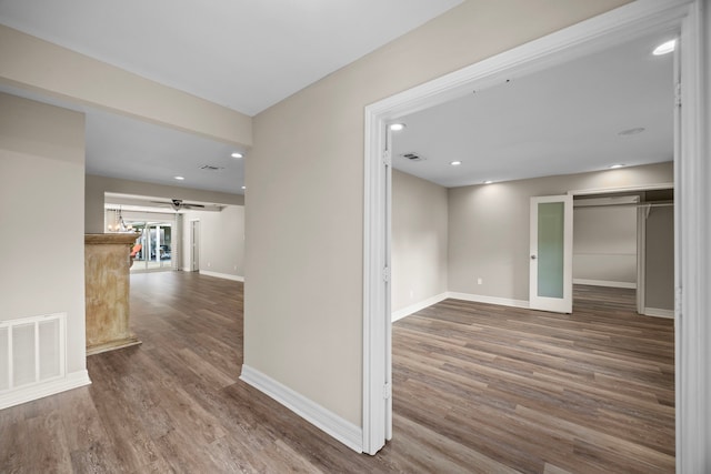 hallway with baseboards, visible vents, wood finished floors, and recessed lighting