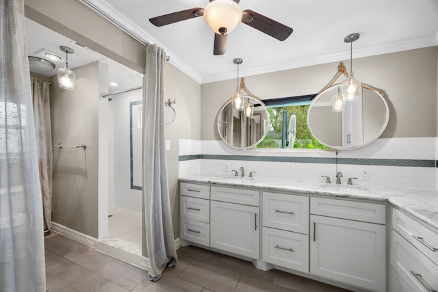 full bath with double vanity, crown molding, a sink, and walk in shower