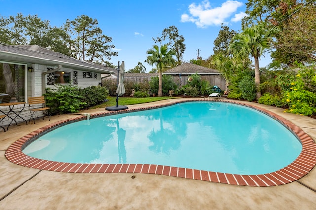 view of swimming pool featuring a fenced in pool, a patio area, a fenced backyard, and a diving board