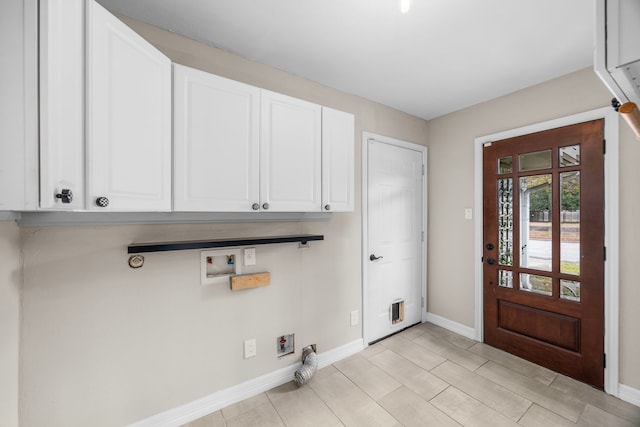 laundry room featuring cabinet space, hookup for a washing machine, baseboards, and electric dryer hookup