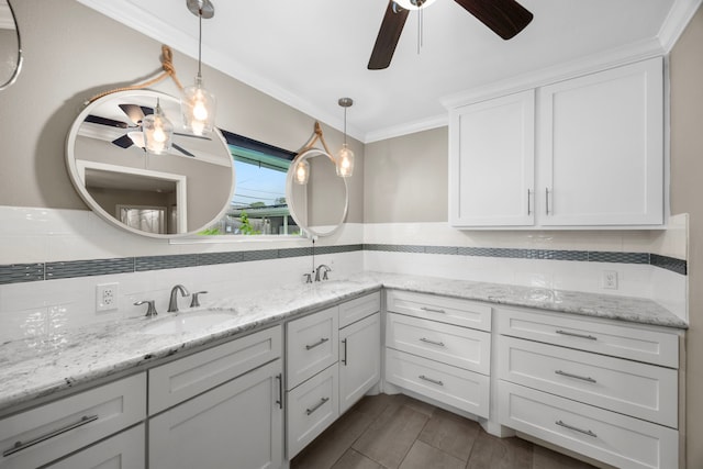 full bathroom featuring double vanity, tasteful backsplash, a sink, and crown molding