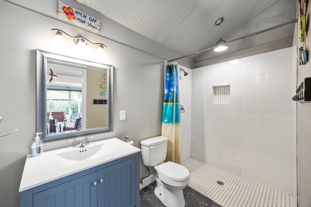 bathroom featuring lofted ceiling, a stall shower, vanity, and toilet