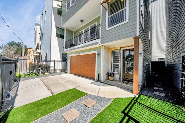 exterior space featuring a garage, stone siding, concrete driveway, and fence