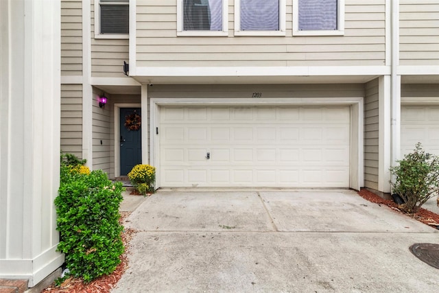 garage with concrete driveway