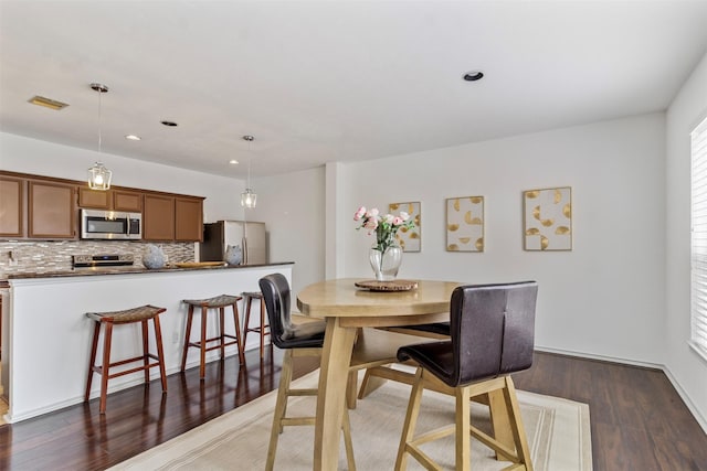 dining area featuring recessed lighting, visible vents, and wood finished floors