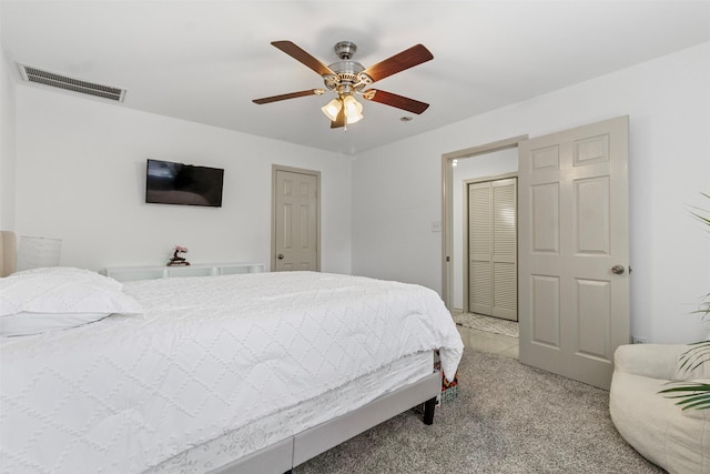 bedroom featuring light carpet, visible vents, and a ceiling fan