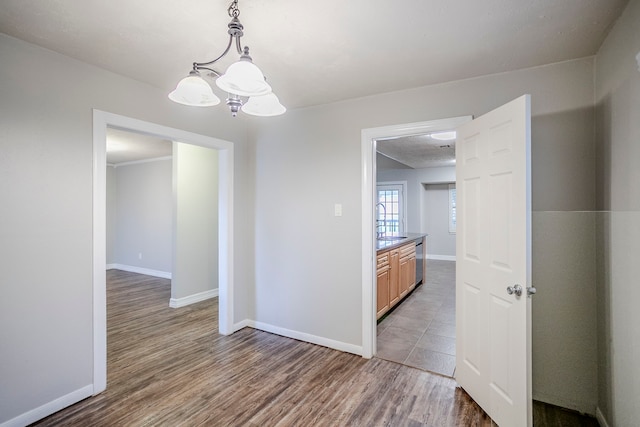 interior space featuring baseboards, dark wood finished floors, and a sink