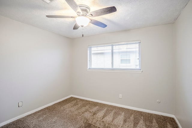 carpeted spare room featuring a textured ceiling, ceiling fan, and baseboards