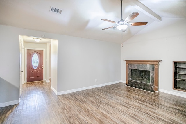 unfurnished living room featuring a fireplace, wood finished floors, visible vents, and baseboards