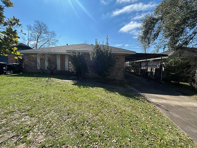 single story home with brick siding and a front yard