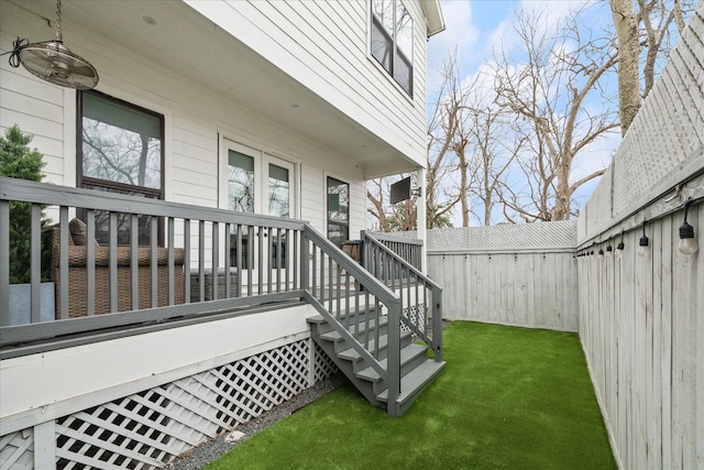 exterior space featuring a fenced backyard, stairs, and a deck