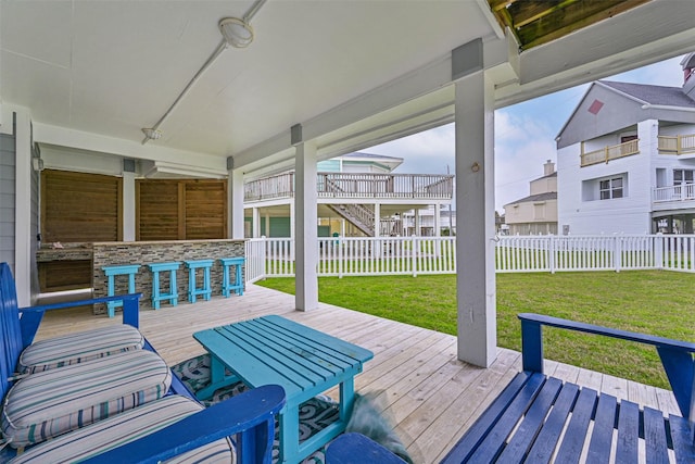 view of patio / terrace featuring fence, a deck, and a bar