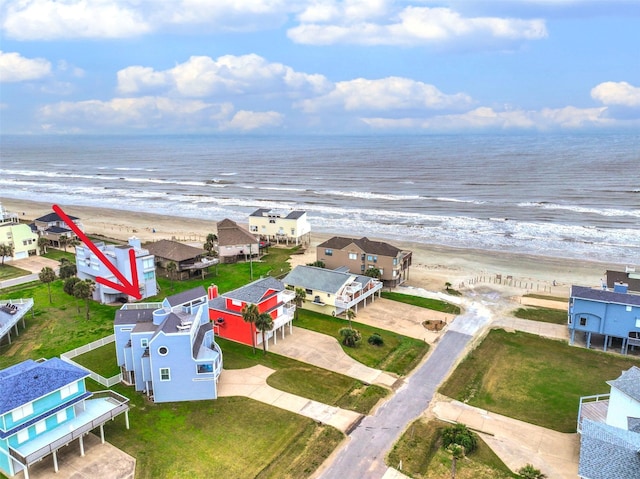 aerial view featuring a water view, a residential view, and a view of the beach