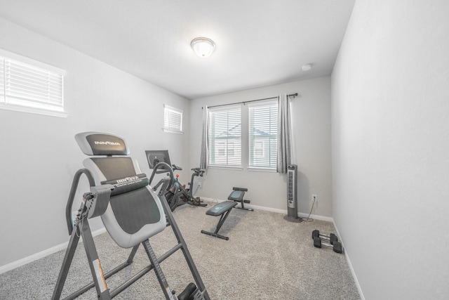 workout area with baseboards and carpet flooring