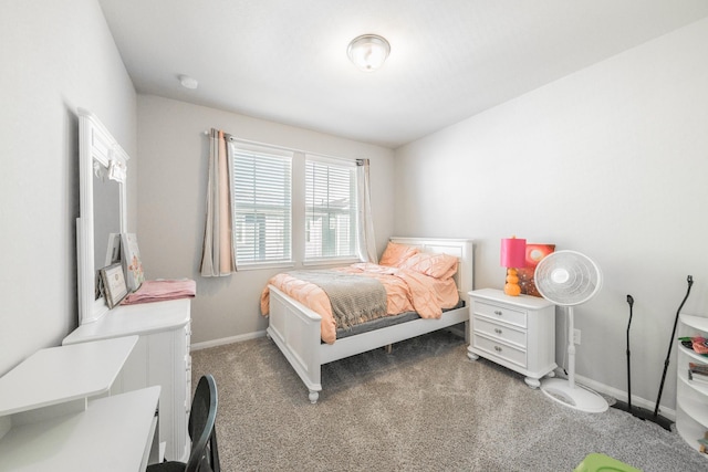 bedroom with dark carpet and baseboards