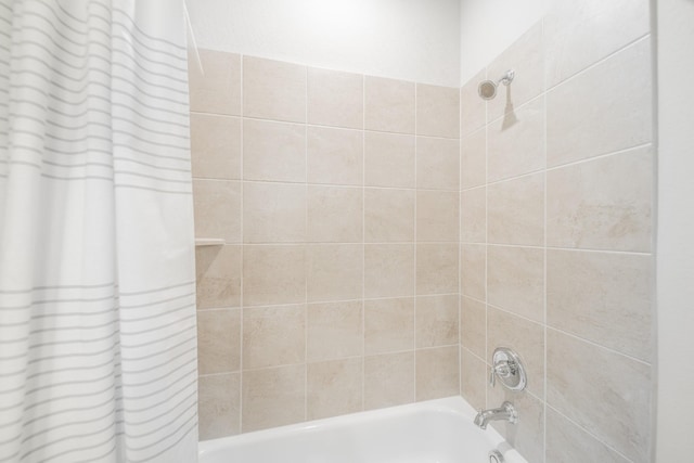 bathroom with shower / bath combo with shower curtain