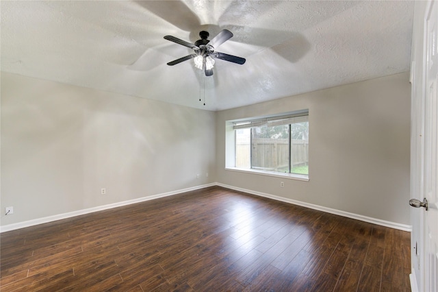 unfurnished room with dark wood-type flooring, a textured ceiling, baseboards, and a ceiling fan