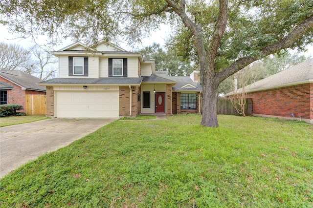 traditional-style home featuring driveway, brick siding, a front yard, and fence