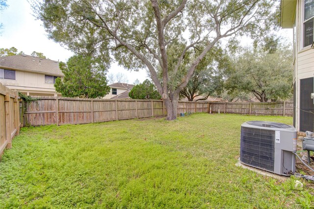 view of yard with cooling unit and a fenced backyard