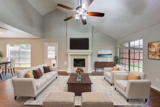 16318 Elmwood Point Ln, Sugar Land, TX 77498 - living area featuring high vaulted ceiling, ceiling fan, wood finished floors, baseboards, and a fireplace