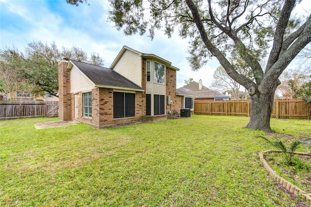 back of property with brick siding, a fenced backyard, a lawn, and central air condition unit