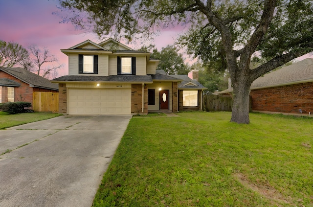 traditional-style home featuring a garage, concrete driveway, fence, a front lawn, and brick siding