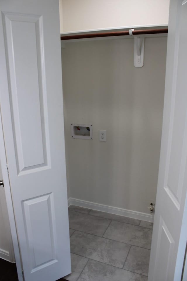 clothes washing area with laundry area, hookup for a washing machine, and baseboards