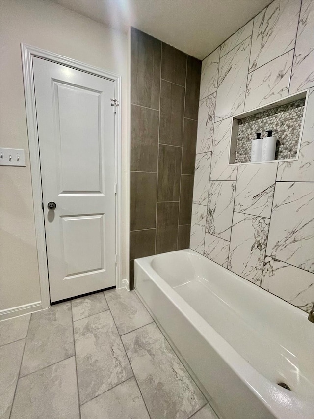 full bath with  shower combination and baseboards