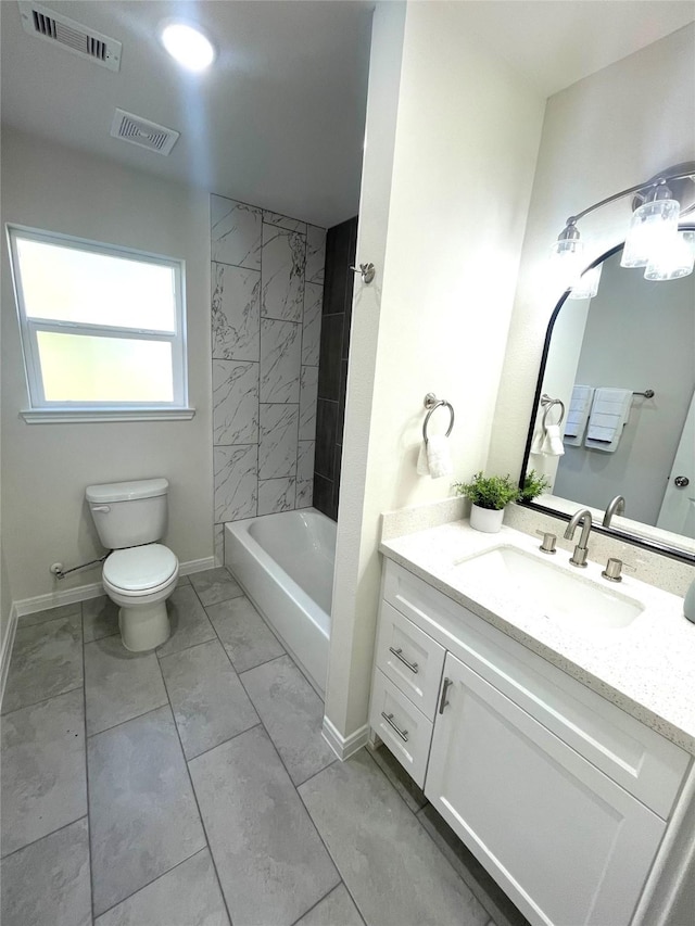 bathroom featuring toilet, baseboards, visible vents, and vanity